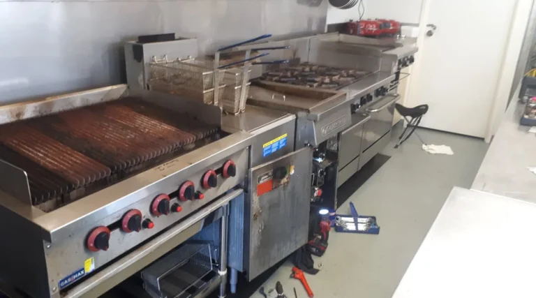 Commercial kitchen line with a chargrill, fryer and gas range