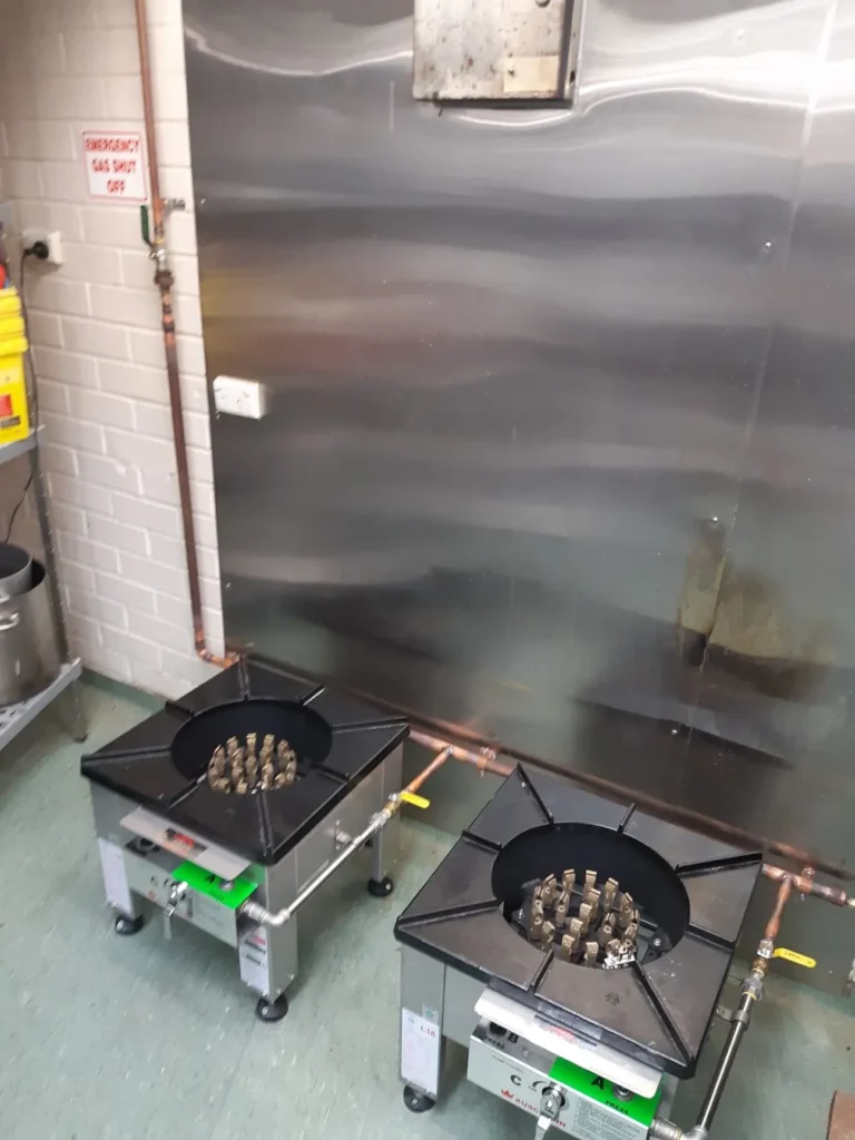 Two gas stockpot burners in a commercial kitchen