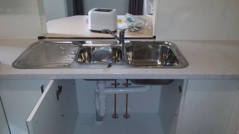 New double stainless steel kitchen sink with its plumbing