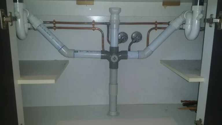 New PVC waste pipework under a double sink cabinet