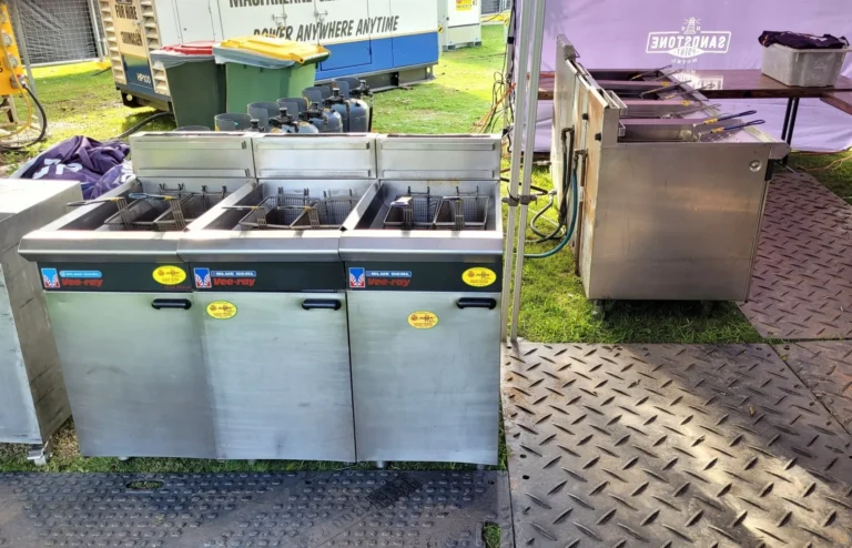 Rental gas deep fryers set up outdoors at an event