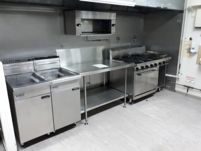 Twin fryers and a gas range in a new commercial kitchen